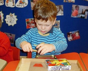 A small boy playing indoor game