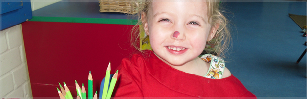 Close up of girl smiling with three pencils in hand